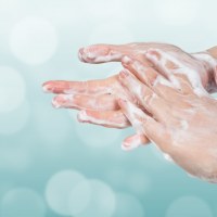 Washing hands. Hygiene concept. Blue bokeh background.