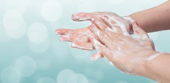 Washing hands. Hygiene concept. Blue bokeh background.
