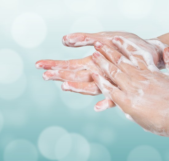 Washing hands. Hygiene concept. Blue bokeh background.